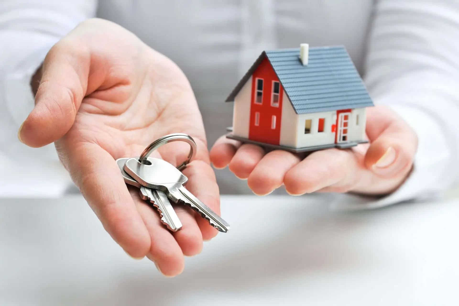 Keys and small house representing buying a home in Murrieta California