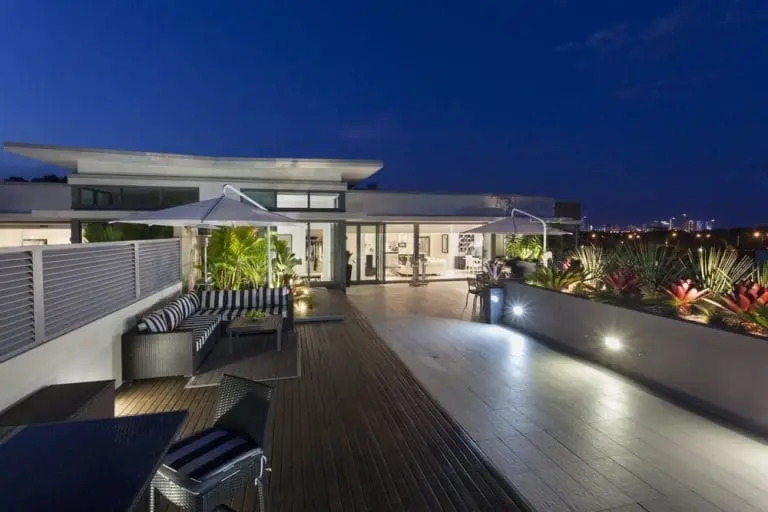 A modern Temecula Valley home lit at dusk with a pool in the foreground