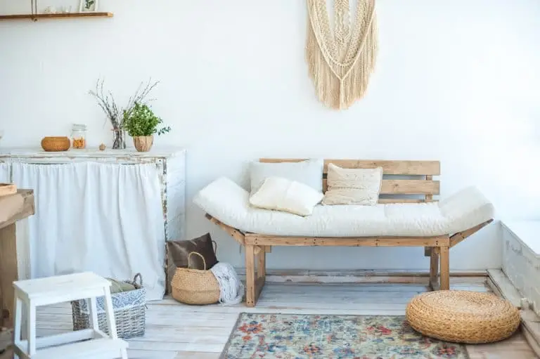 A freshly painted, styled living room with a sofa and natural light
