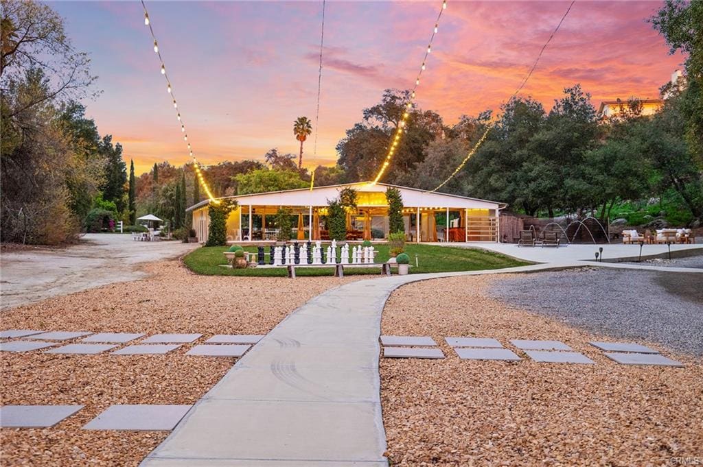 Temecula Wine Country home exterior at sunset with landscaped yard recently sold by Marchena Home Team