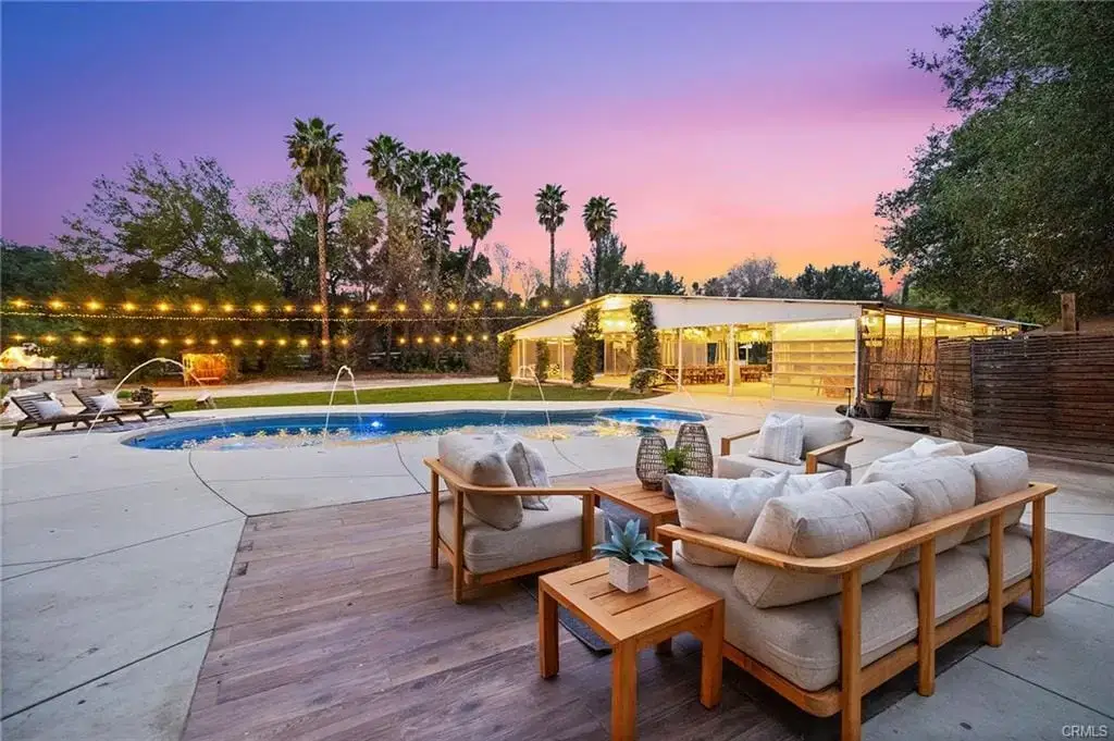 Temecula Wine Country backyard with pool and outdoor seating area at sunset recently sold by Marchena Home Team
