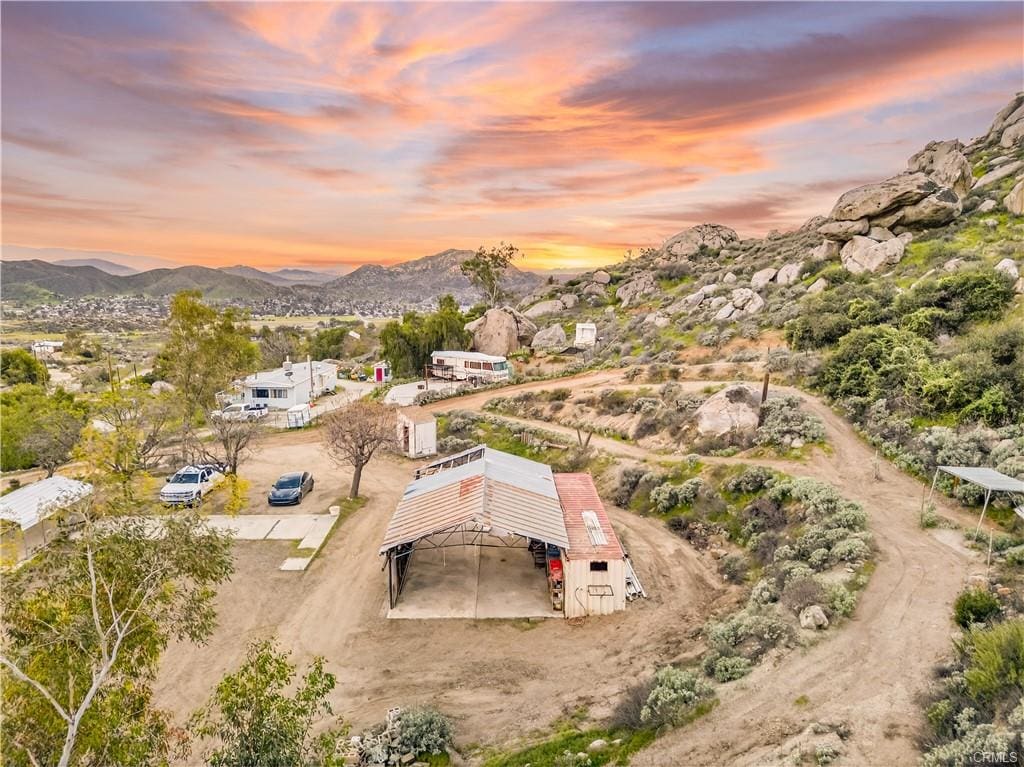 Aerial view of usable land with pad and structure on 13.9 acre property for sale in Homeland CA