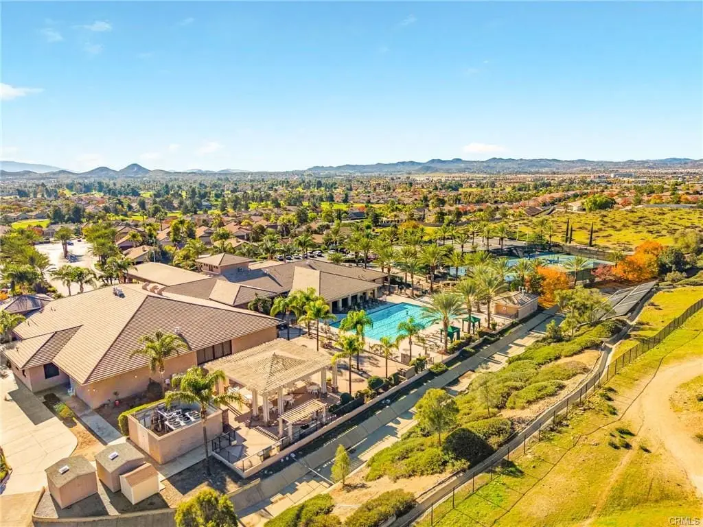Aerial view of The Oasis 55+ community in Menifee CA featuring clubhouse, pool, and resort style amenities