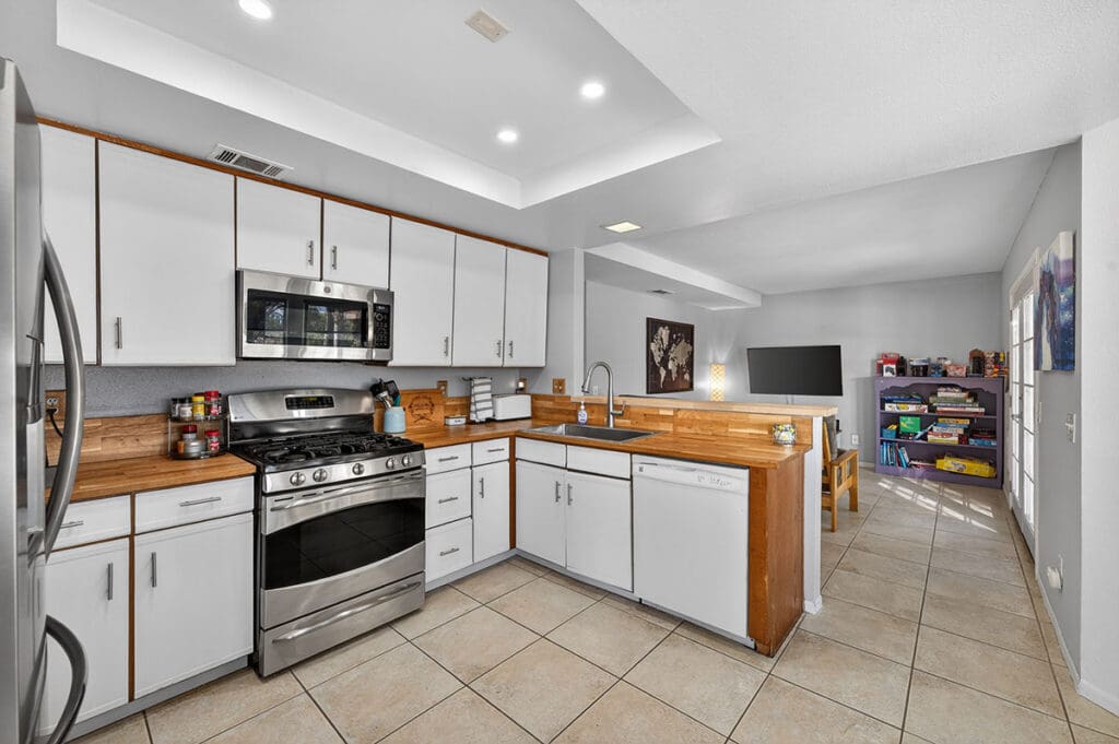 Open concept kitchen with butcher block countertops and eating bar in Temecula pool home