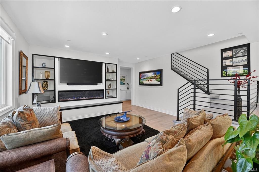 Upgraded living room at 36275 Firelight in Wildomar CA with custom entertainment wall and modern fireplace