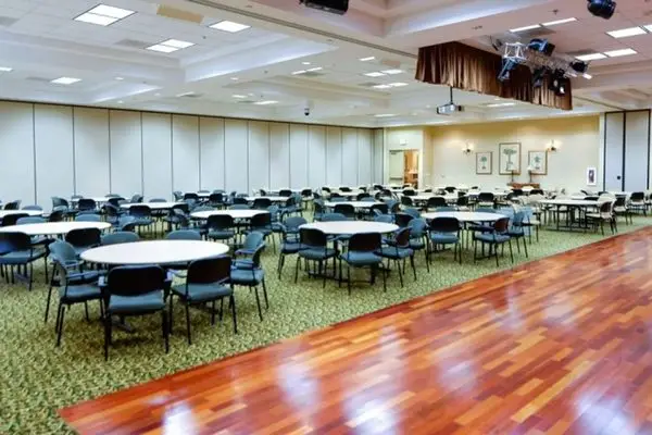 Ballroom with dance floor and banquet tables at The Oasis in Menifee