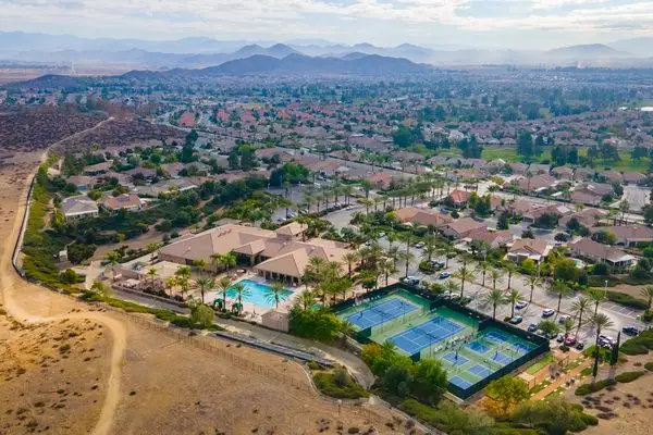 Aerial community view of homes and mountains at The Oasis in Menifee