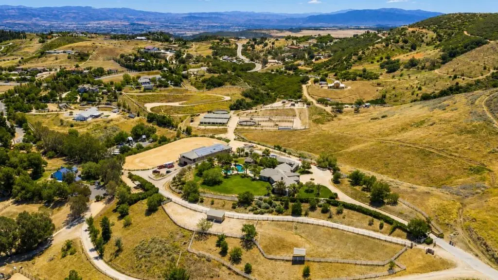 Aerial view of estate and equestrian properties with paddocks, arenas and rolling hills in Fallbrook, California