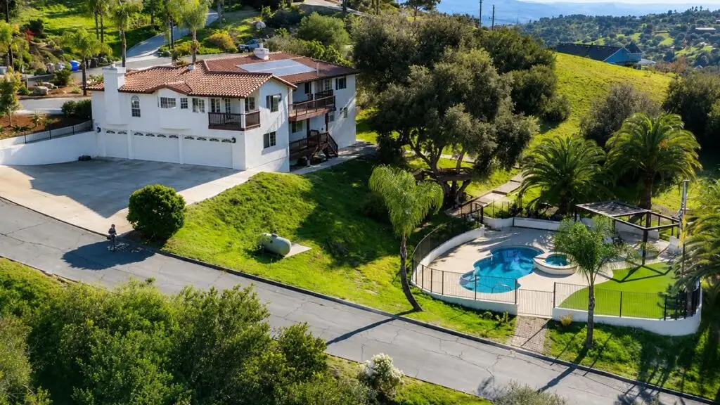 Hillside estate home with pool and oak trees overlooking the Gird Valley area of Fallbrook, California